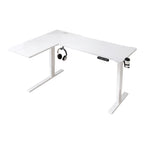 Photo de face du bureau d'angle assis-debout blanc Vertex Pro sur fond blanc isolé montrant son design minimaliste avec le support de casque et le porte-gobelet.