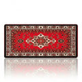 Tapis de souris Atlas Heritage XXL en tissu micro-tissé, enroulé pour montrer son design persan traditionnel rouge et noir sur un fond blanc.