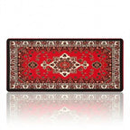 Tapis de souris Atlas Heritage XXL en tissu micro-tissé, enroulé pour montrer son design persan traditionnel rouge et noir sur un fond blanc.