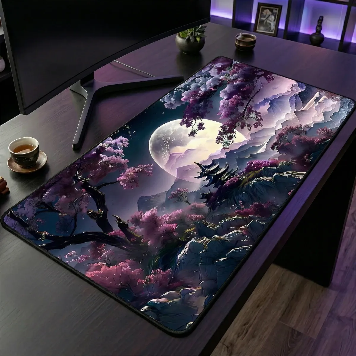 Gros plan en angle sur le tapis de souris Tsuki Eclipse XXL sur un bureau en bois : détails texture micro-textile et bords brodés.